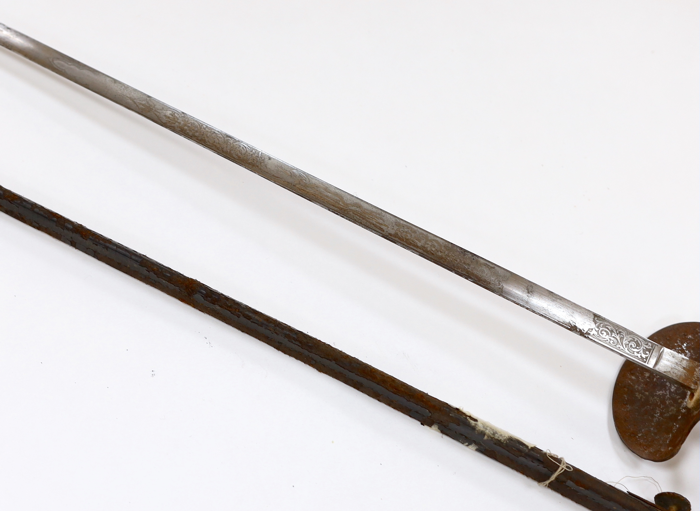 An English cut steel hilted dress court sword, c.1900, polished blade etched at forte, iron hilt slightly rusted, in its leather scabbard, blade 79cm